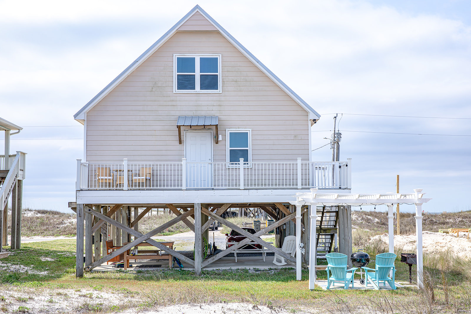 Jellyfish Twist exterior with decks and a string-lit charcoal grilling area